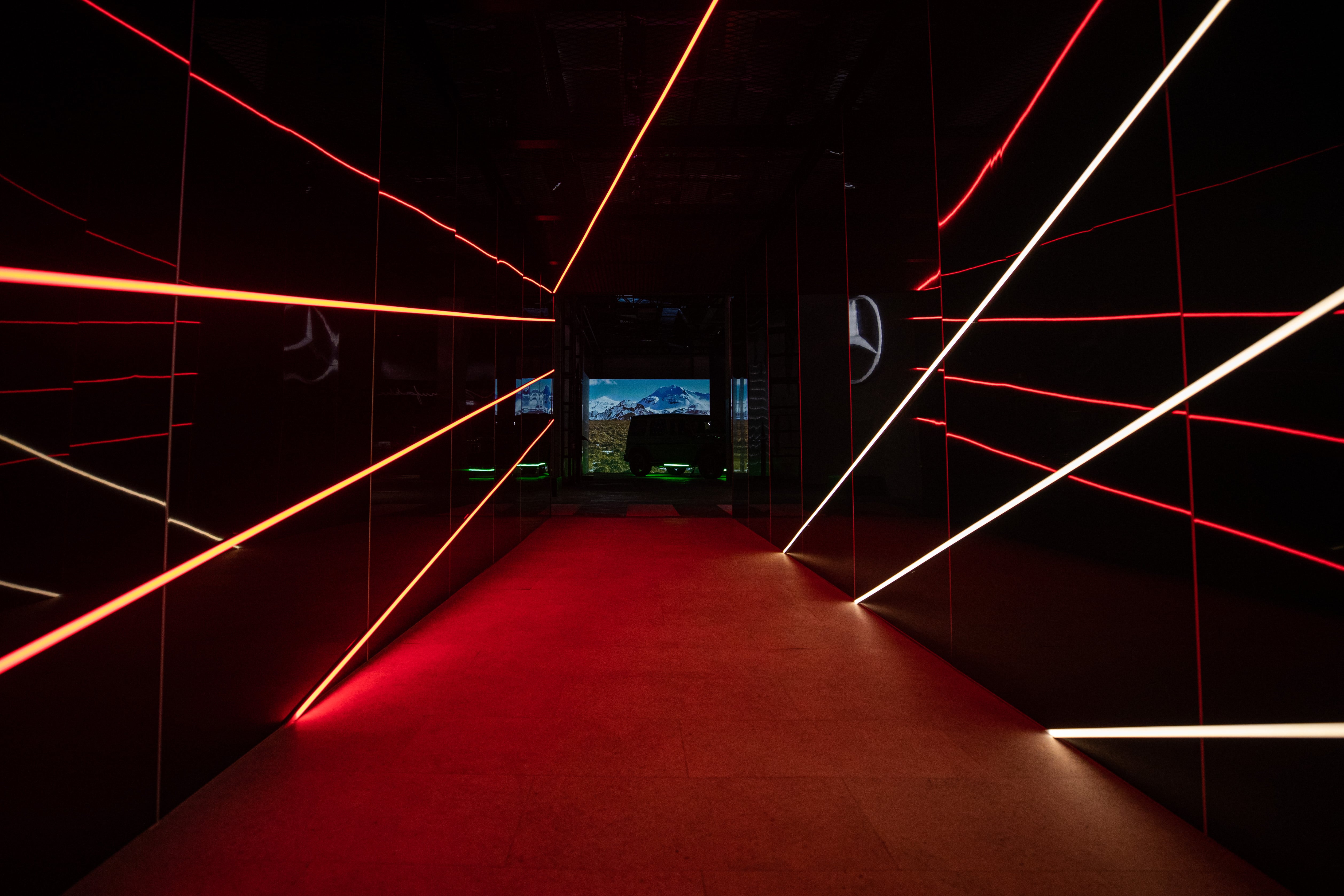 Dim hallway with LED lights leading to Mercedes-Benz showcase room